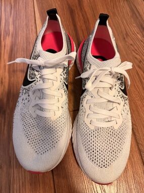 Nike White and Pink Flyknit Running Sneakers with Black Swoosh